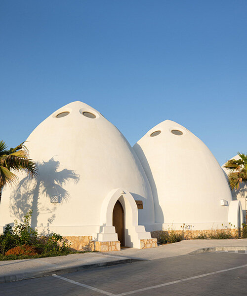 circular skylights punctuate all-white dome structures of EMKAAN's al fanar school in dubai