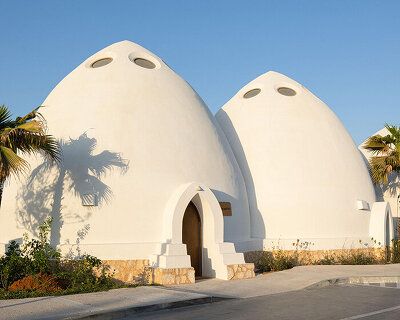 circular skylights punctuate all-white dome structures of EMKAAN's al fanar school in dubai