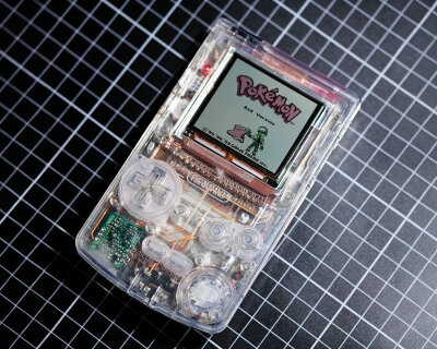 custom nintendo game boy features clear case and copper wires on transparent circuit board