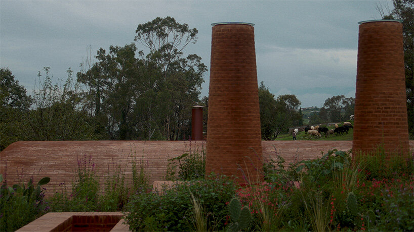 GOMA tucks vaulted cabin into mexican landscape with twin brick towers rising above