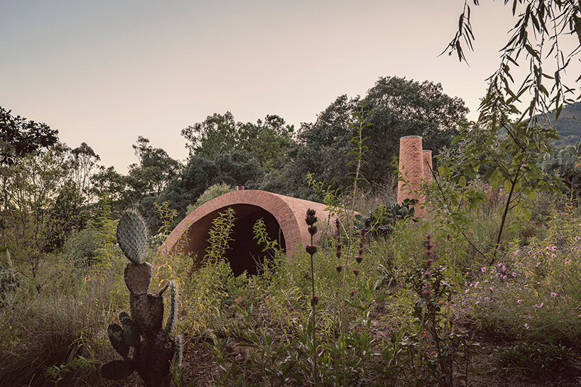 GOMA tucks vaulted cabin into mexican landscape with twin brick towers rising above
