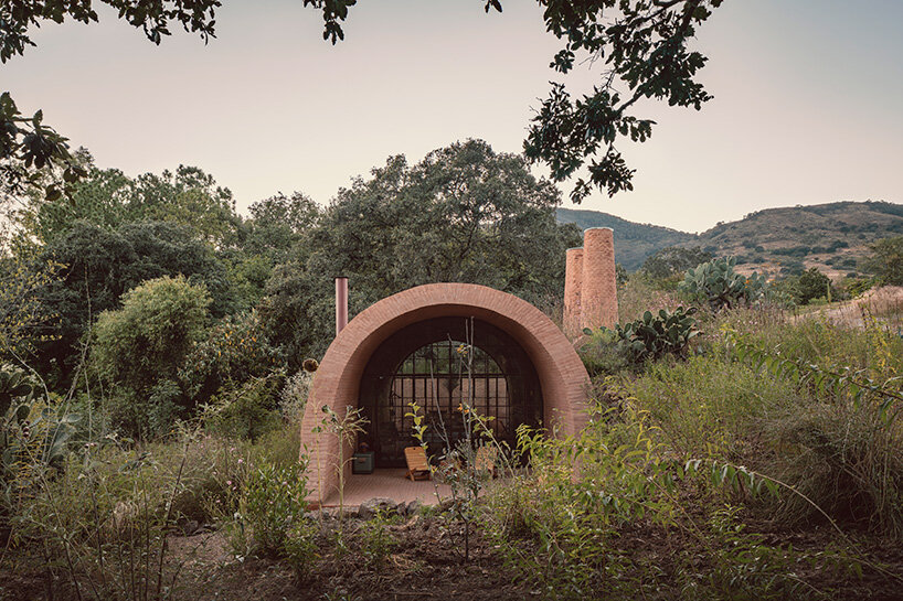 GOMA tucks vaulted cabin into mexican landscape with twin brick towers rising above