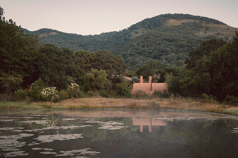 GOMA tucks vaulted cabin into mexican landscape with twin brick towers rising above