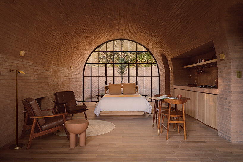 GOMA tucks vaulted cabin into mexican landscape with twin brick towers rising above