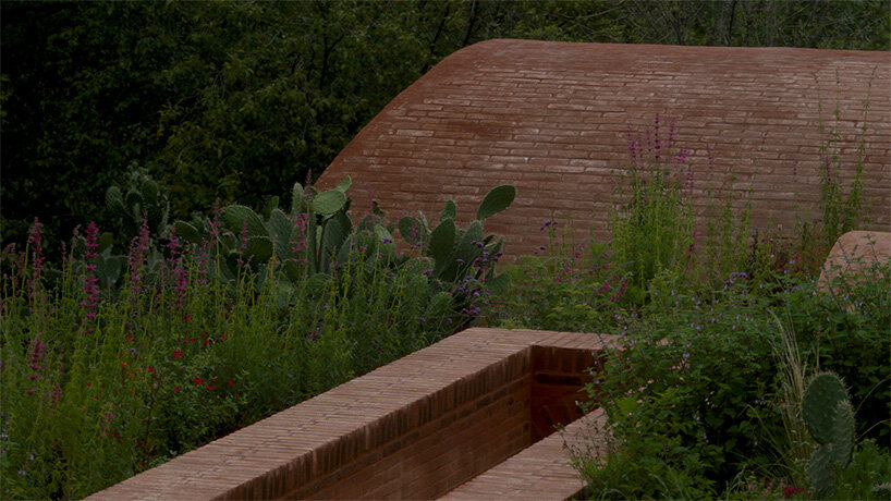 GOMA tucks vaulted cabin into mexican landscape with twin brick towers rising above