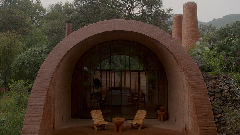 GOMA tucks vaulted cabin into mexican landscape with twin brick towers rising above