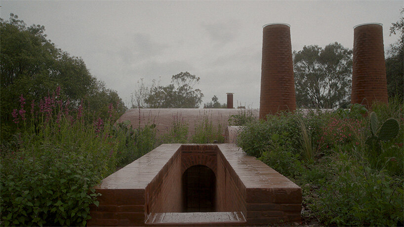 GOMA tucks vaulted cabin into mexican landscape with twin brick towers rising above