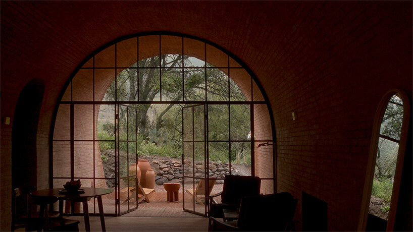 GOMA tucks vaulted cabin into mexican landscape with twin brick towers rising above