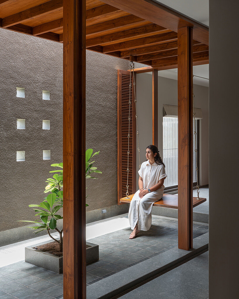 studio nirbaadh's H-house is a composition of layered walls and brick screens in india