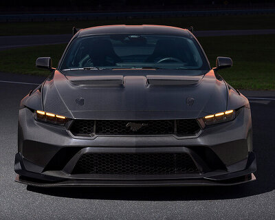carbon fiber surfaces give glimmering presence to mustang GTD liquid carbon in monterey