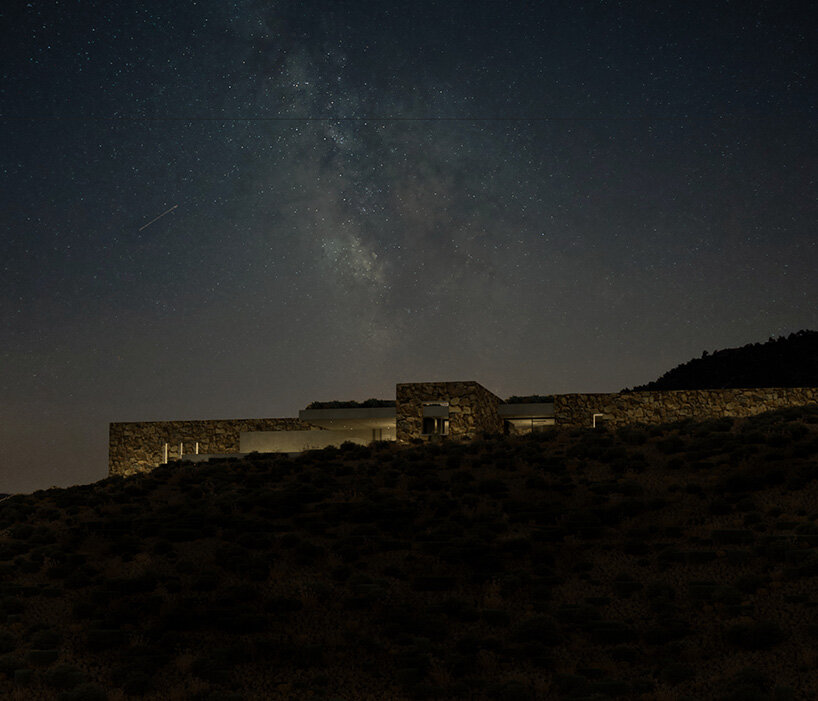 onus embeds net-zero island residence into the greek landscape using local materials