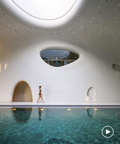 wutopia lab carves soft white caving interiors for pebble-shaped mountain hotel in china