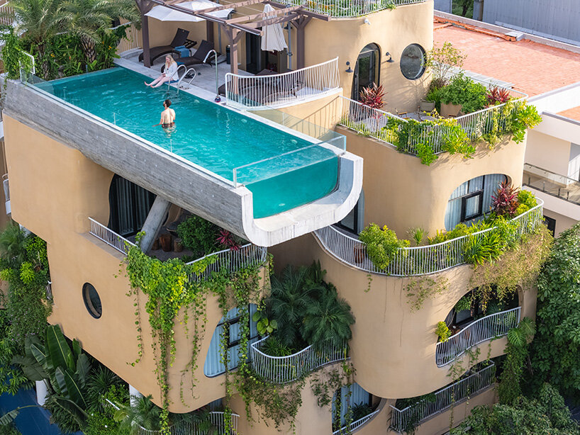rooftop pool cantilevers from the facade of ho khue architects' hotel in vietnam