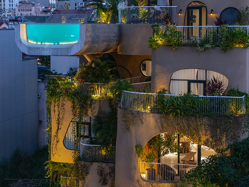 rooftop pool cantilevers from the facade of ho khue architects' hotel in vietnam