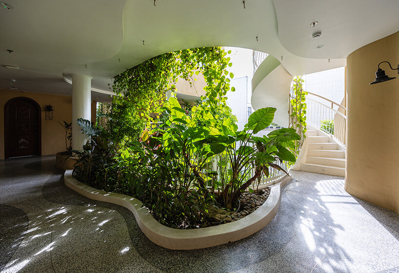 rooftop pool cantilevers from the facade of ho khue architects' hotel in vietnam