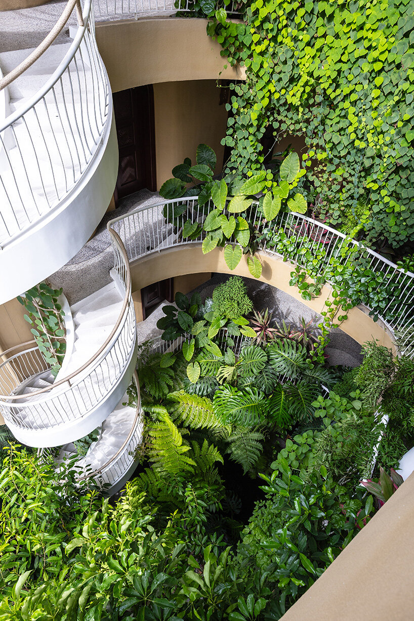 rooftop pool cantilevers from the facade of ho khue architects' hotel in vietnam