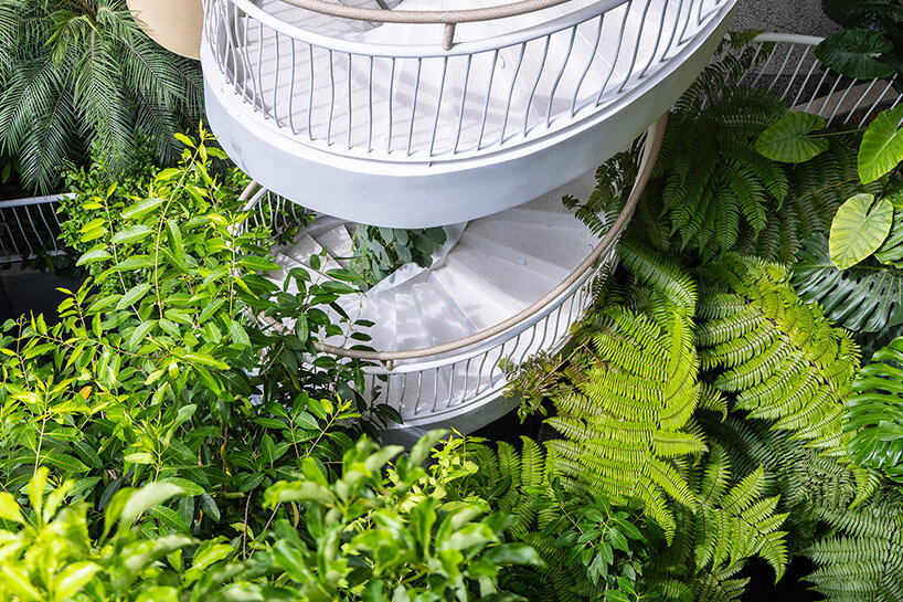 rooftop pool cantilevers from the facade of ho khue architects' hotel in vietnam