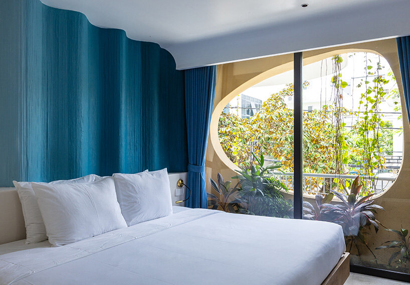 rooftop pool cantilevers from the facade of ho khue architects' hotel in vietnam