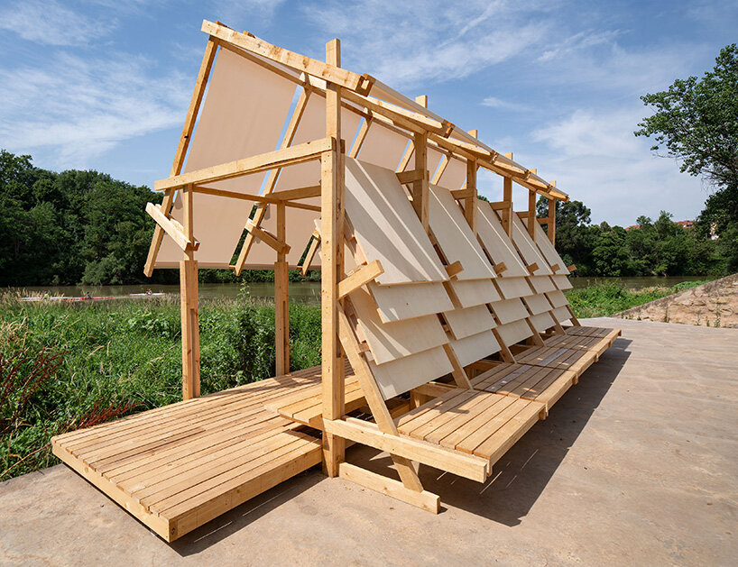 shaded wooden pavilion by erazo pugliese reclaims neglected dock along river in spain