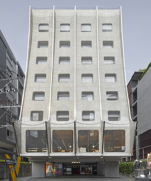 shimmering chain-link facade at ASWA's bangkok hotel draws from traditional thai houses