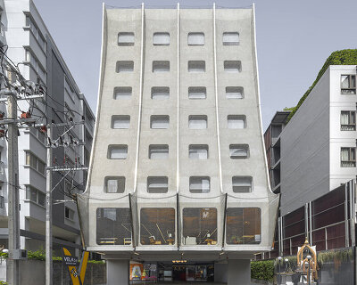 shimmering chain-link facade at ASWA's bangkok hotel draws from traditional thai houses