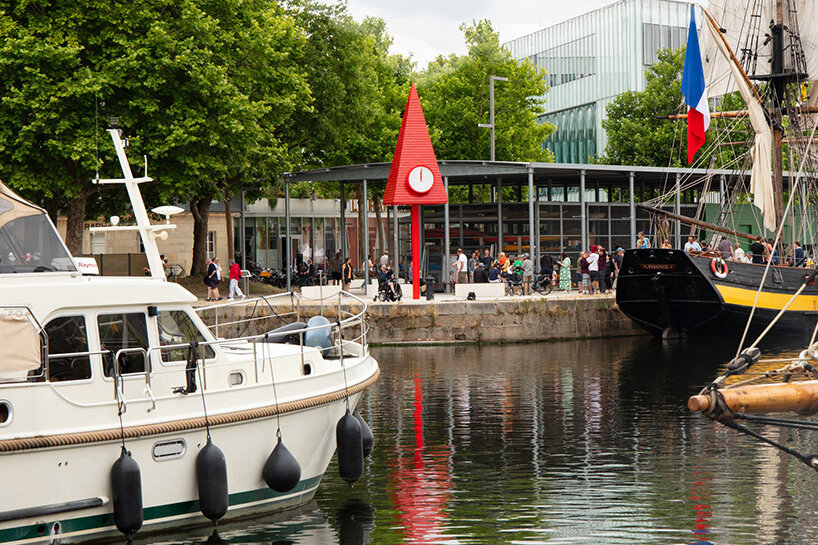 studio 5•5 rises 101st spire in caen as a glowing red monument to the city's millennium