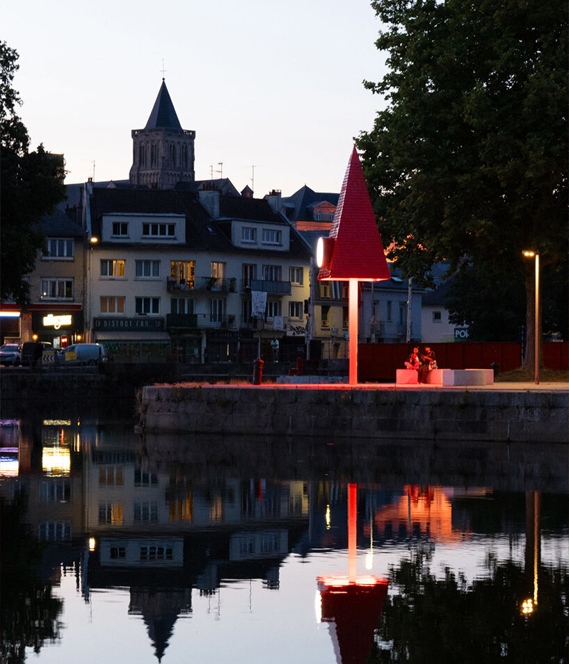 studio 5•5 rises 101st spire in caen as a glowing red monument to the city's millennium