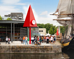 studio 5•5 rises 101st spire in caen as a glowing red monument to the city's millennium