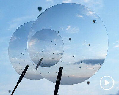 vincent leroy's optical mobile of floating lenses dances with hot air balloons over cappadocia