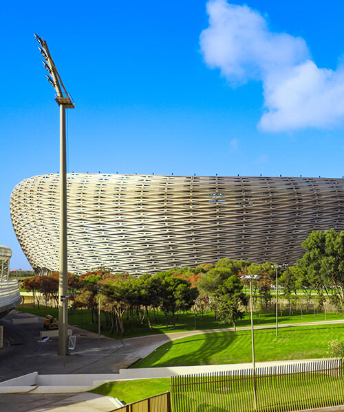 19,200 golden triangles compose luminous facade of populous' stadium in morocco