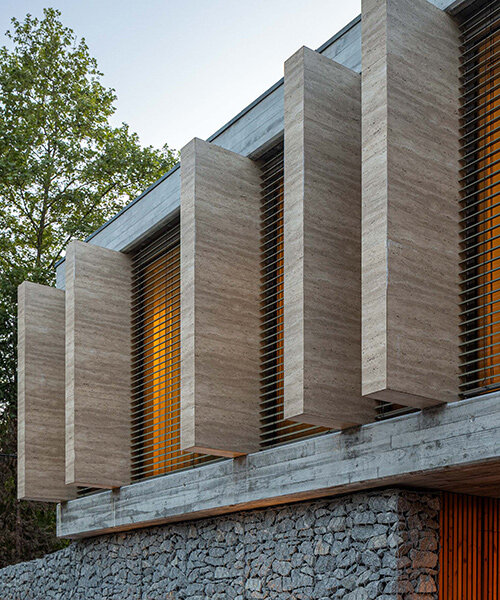artequitectos' CL house pairs gabion walls with a travertine facade in portugal