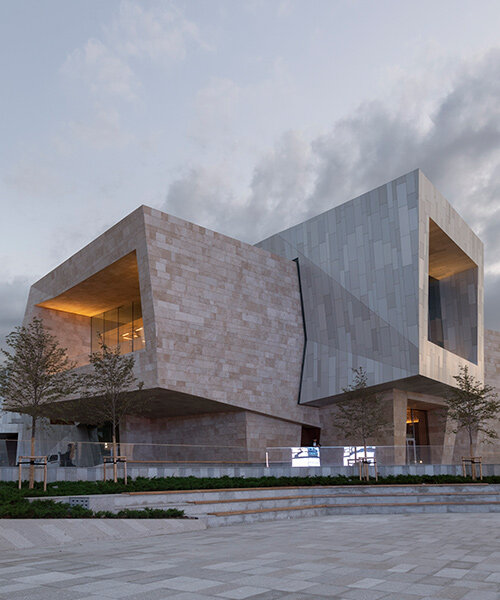 kazakhstan's almaty museum of arts completes as pair of stone and aluminum volumes