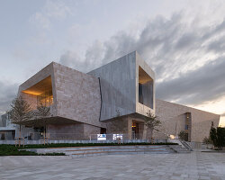 kazakhstan's almaty museum of arts completes as pair of stone and aluminum volumes