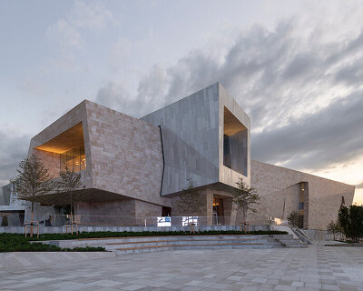 kazakhstan's almaty museum of arts completes as pair of stone and aluminum volumes