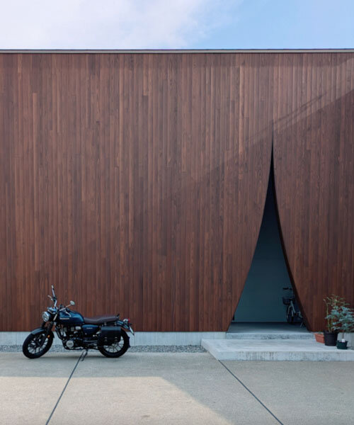 wooden facade parts like a curtain revealing japanese?residence's sunlit interiors