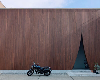 wooden facade parts like a curtain revealing japanese residence's sunlit interiors