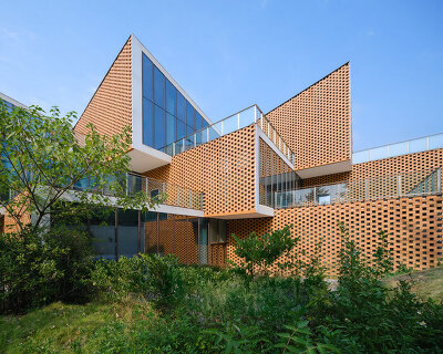 permeable terracotta brick screens wrap kindergarten's stacked volumes by NAN architects