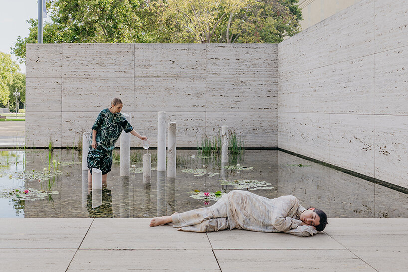 concrete sculptures surface from the pond of mies van der rohe's barcelona pavilion