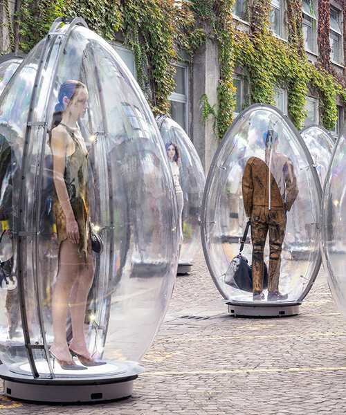 models encased in oversized transparent eggs pop up across milan for diesel's SS26 show