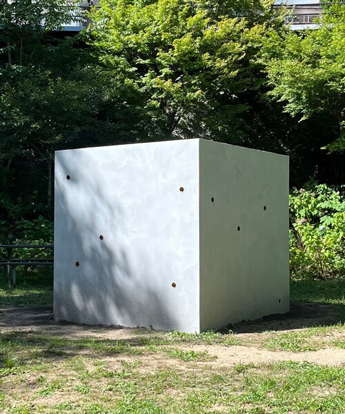 twin concrete cube sculptures link rokko and berlin through tiny video transmission holes
