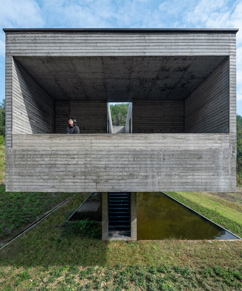 floating concrete structure by moguang studio anchors guesthouse complex in china