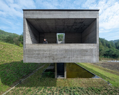 floating concrete structure by moguang studio anchors guesthouse complex in china