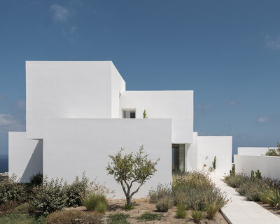 house in oia by kapsimalis architects embeds white prisms along greek volcanic landscape
