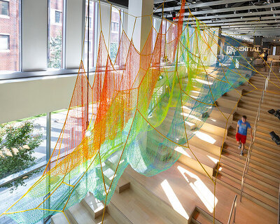 janet echelman suspends lightweight, woven installation within the MIT museum
