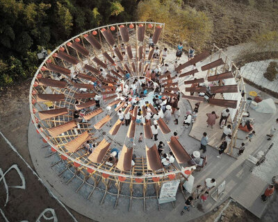 ladders turn into circular framework for climbing amphitheater in rural chinese town