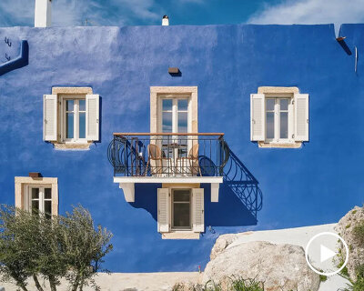 vibrant blue facade brings new life to the monk retreat on leros island, greece