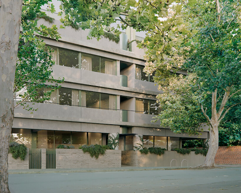 monolithic apartment complex contrasts with verdant fitzroy streetscape in melbourne
