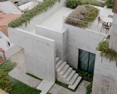 renovated porto residence reimagines hillside terraces with stepped concrete layers