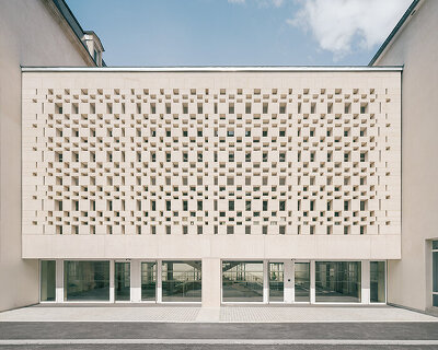 perforated stone gallery by agence vulcano-gibello connects law faculty buildings in france
