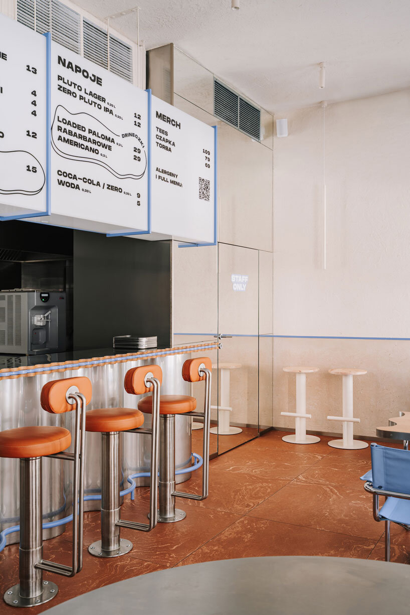 caramel tones and fluid undulating lines form melting interior of pluto burger bar in poland